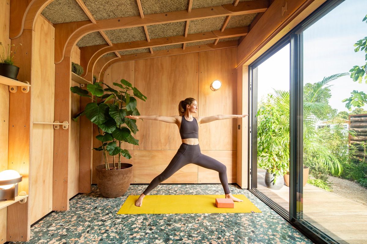 Yoga in warrior pose by the sliding doors
